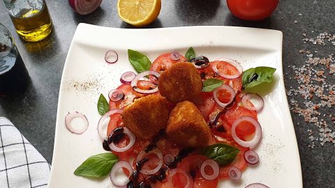 Fried mozzarella cheese on tomato carpaccio