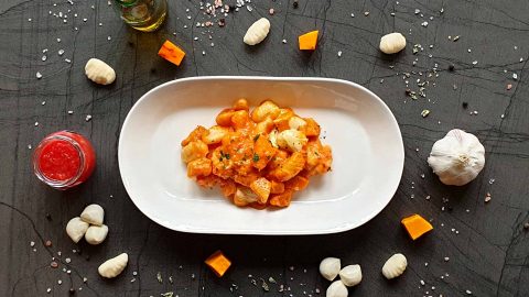 Baked gnocchi with pumpkin in tomato cream sauce