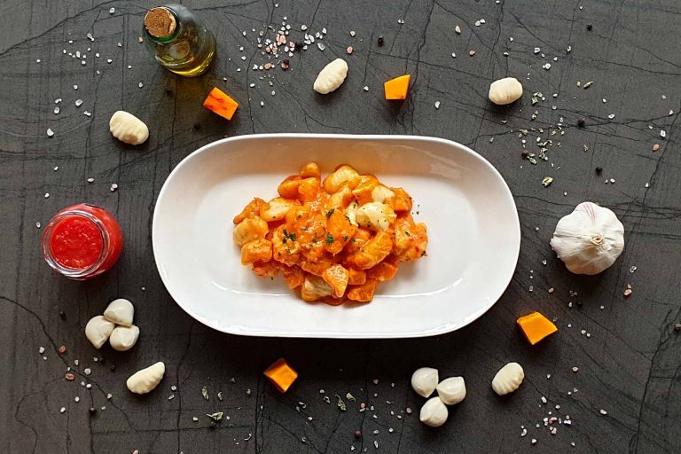 Baked gnocchi with pumpkin in tomato cream sauce
